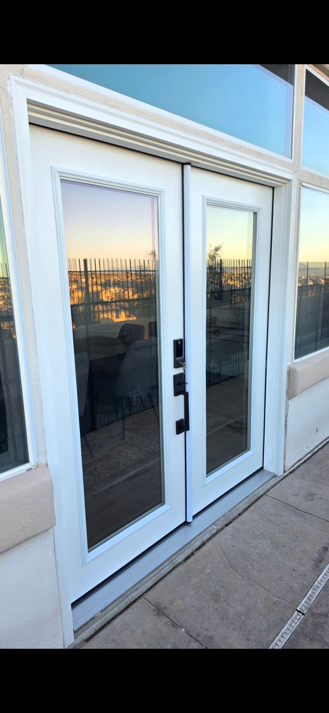 Glass door installation with sunset view